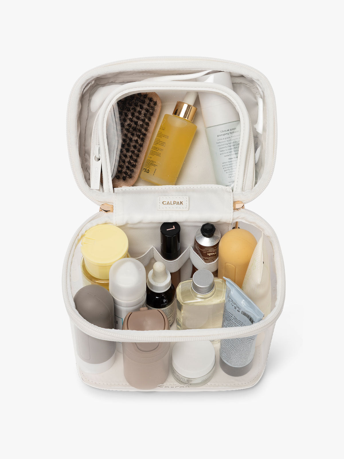 CALPACK Clear Train Case in White, shown as open with toiletries in the top and bottom compartment; CTC2401-WHITE