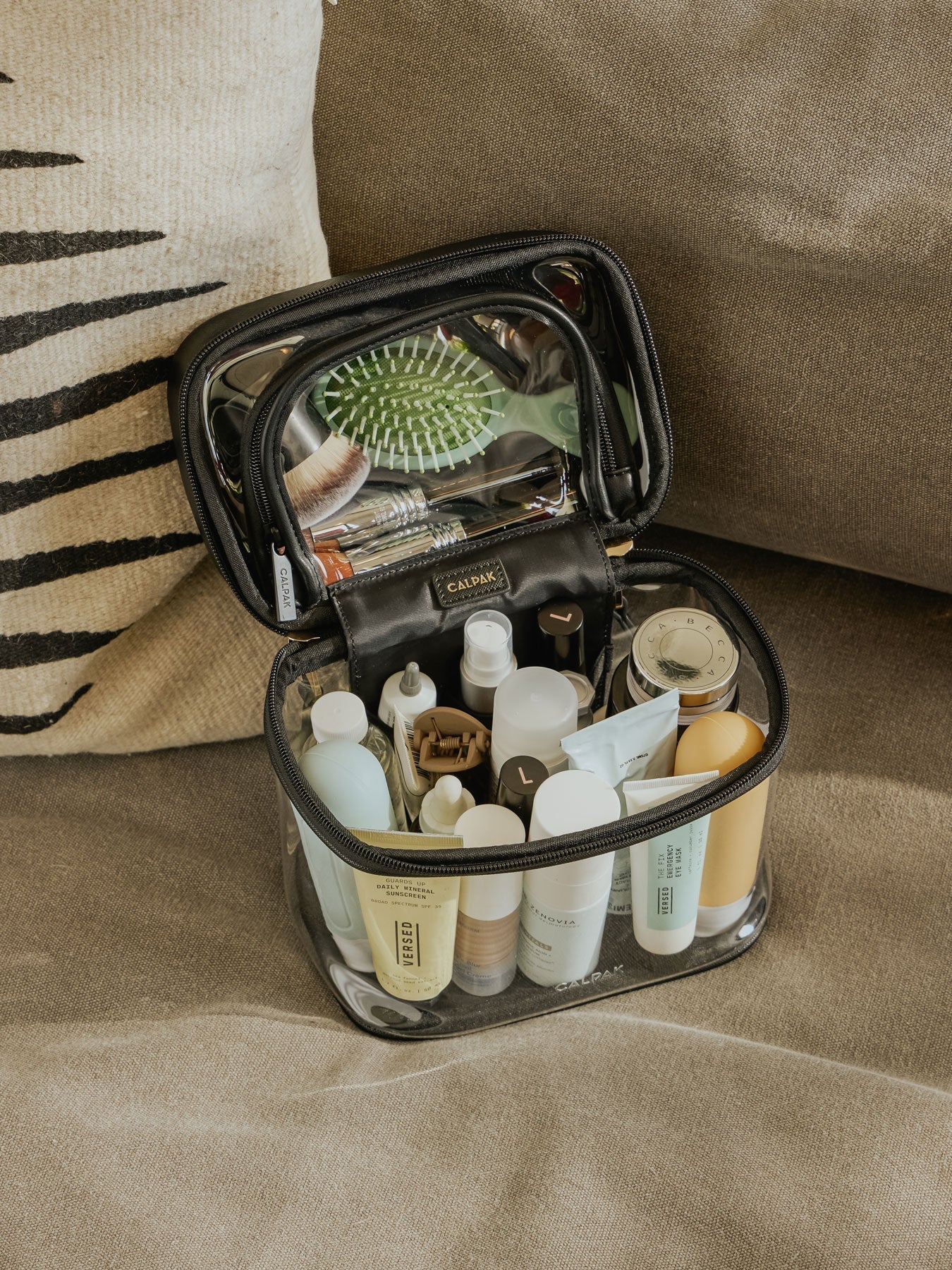 CALPAK Clear Train Case with Top Compartment for toiletries and cosmetics in black; CTC2401-BLACK