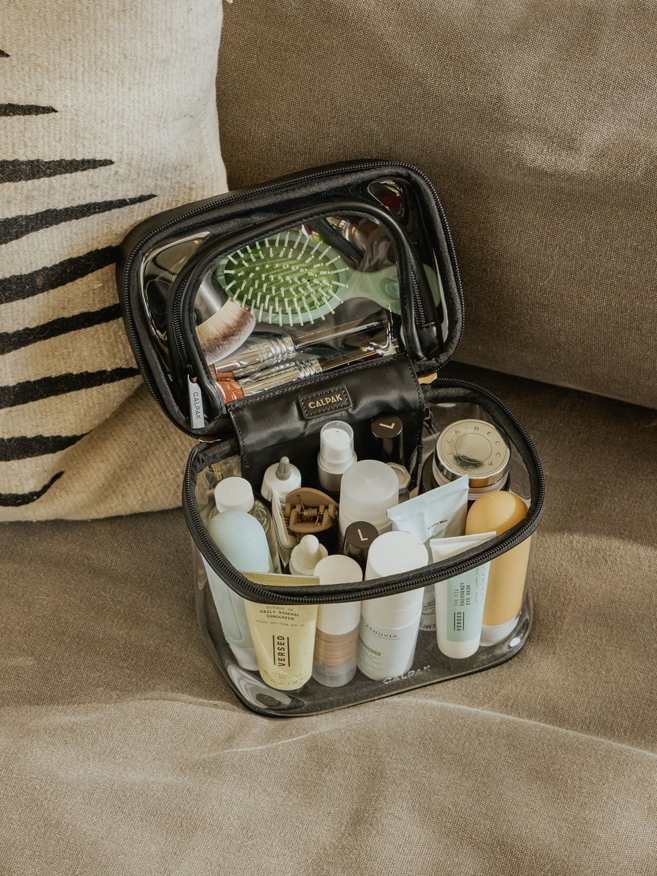 CALPAK Clear Train Case with Top Compartment for toiletries and cosmetics in black; CTC2401-BLACK