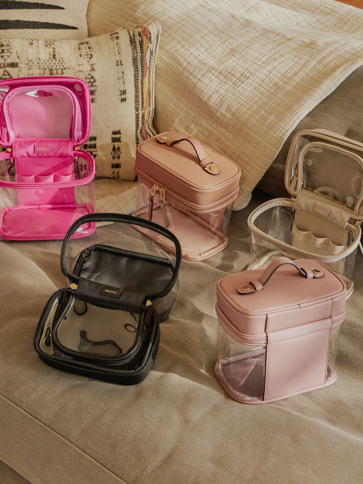 CALPAK Clear Train Case with Top Compartment in dragonfruit, black, caramel, stone, and mauve; CTC2401-BLACK, CTC2401-MAUVE, CTC2401-STONE, CTC2401-CARAMEL, CTC2401-DRAGONFRUIT
