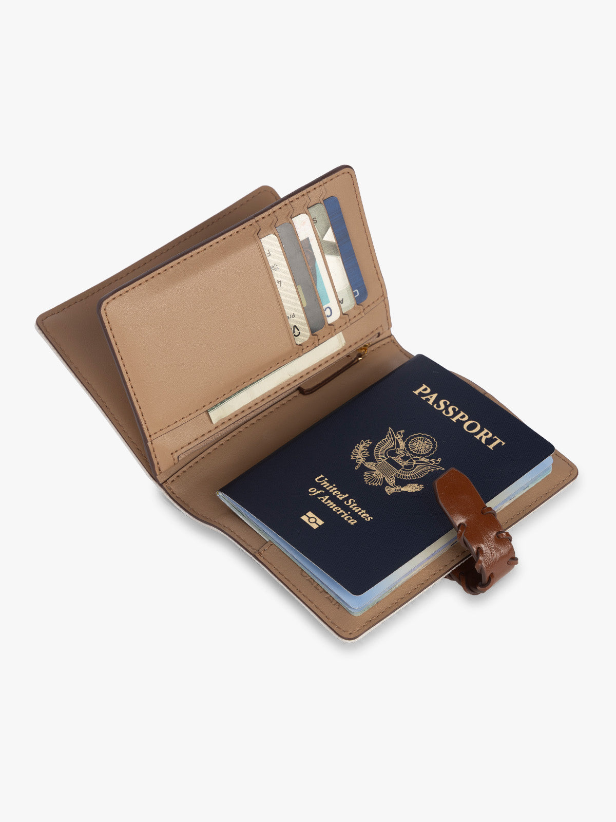 Opened with passport and card slots of CALPAK Colette Multi Passport Wallet in beige canvas material and brown finishings in Natural Brown; CLPW2601-NATURAL-BROWN