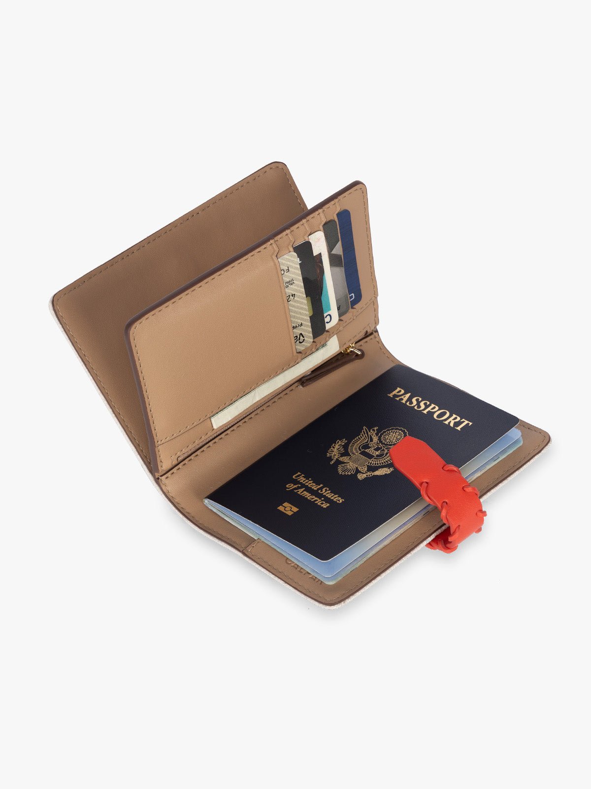 Opened with passport and card slots of CALPAK Colette Multi Passport Wallet in beige canvas material and red finishings in Natural Tomato; CLPW2601-NATURAL-TOMATO