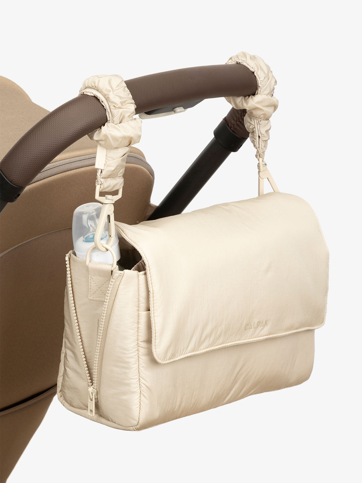 CALPAK Convertible Stroller Caddy Crossbody with included stroller straps in beige oatmeal; SCB2401-OATMEAL