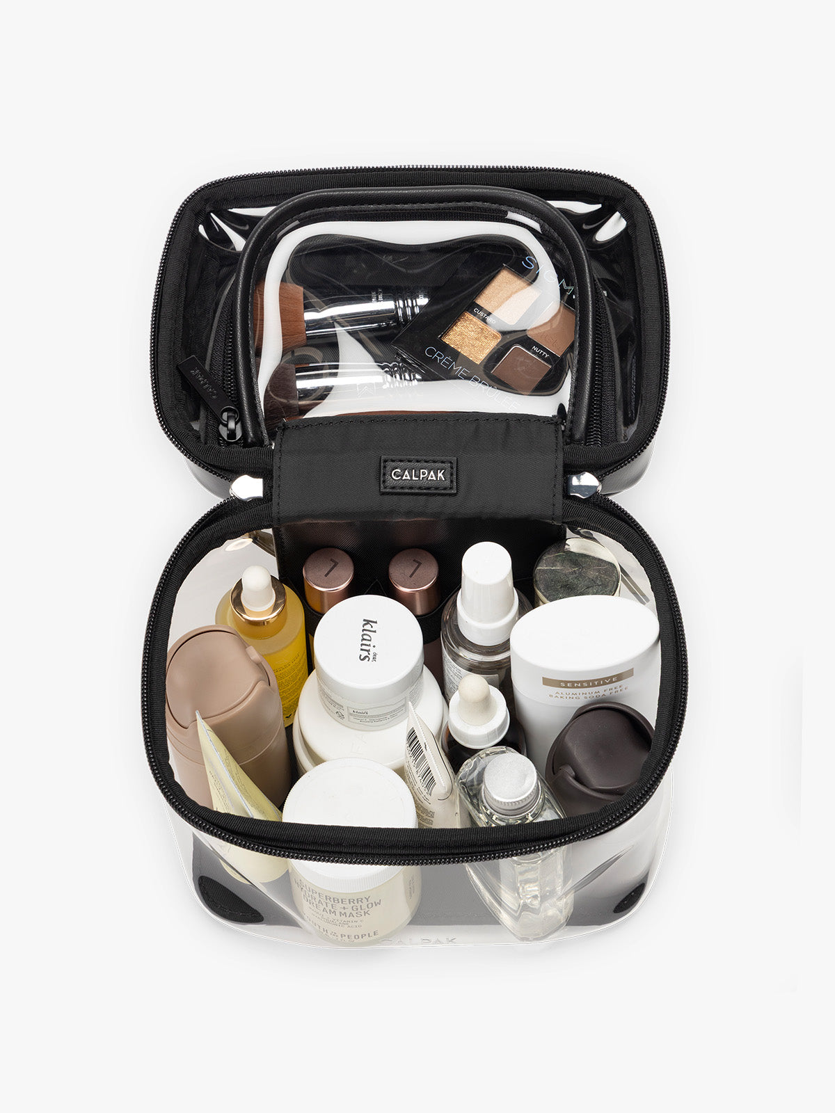 Toiletries and makeup in the Opened and empty CALPAK Clear Train Case in Glazed Black; CTC2401-GLAZED-BLACK