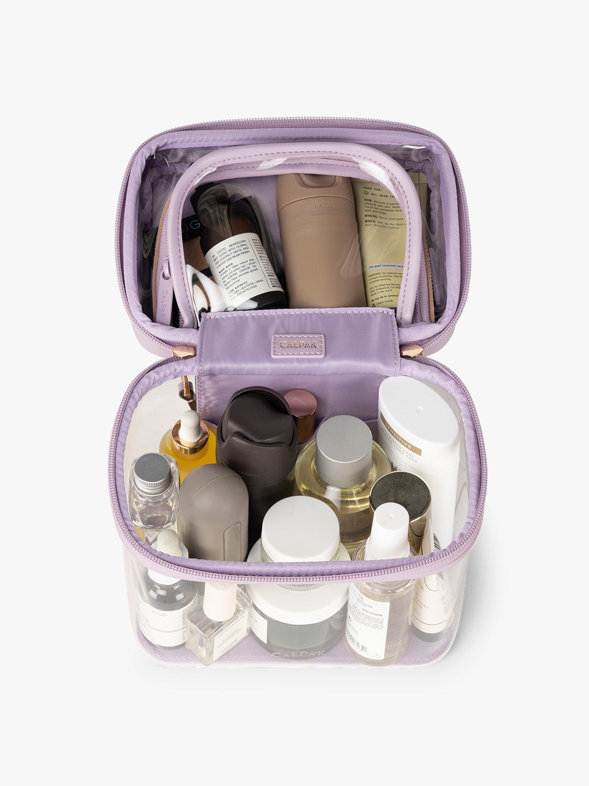 Makeup and toiletries in the CALPAK Clear Train Case in purple lavender; CTC2401-LAVENDER
