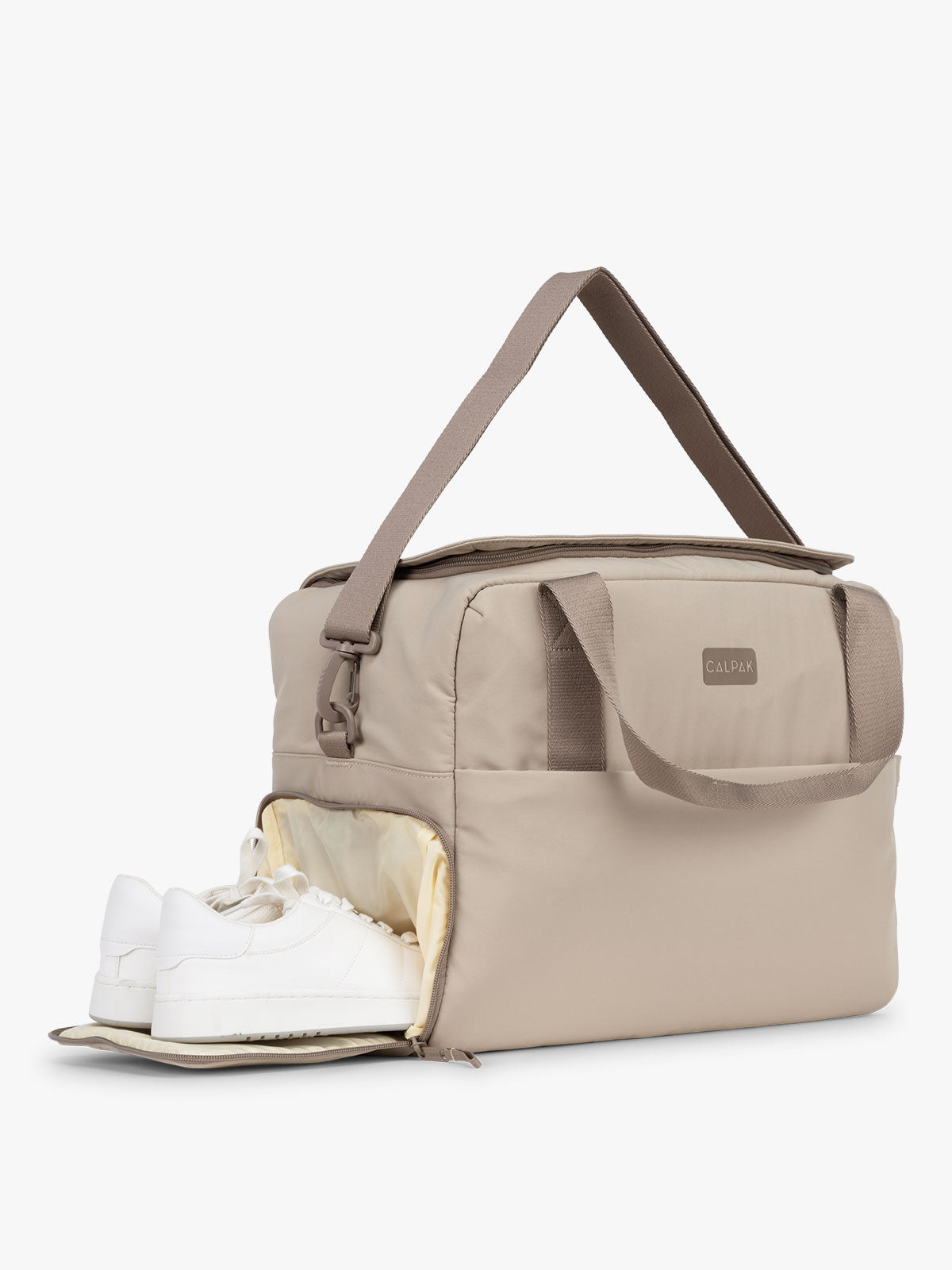 CALPAK Laptop Duffel in beige Greige side view with shoe comparment on white background; DCN2401-GREIGE