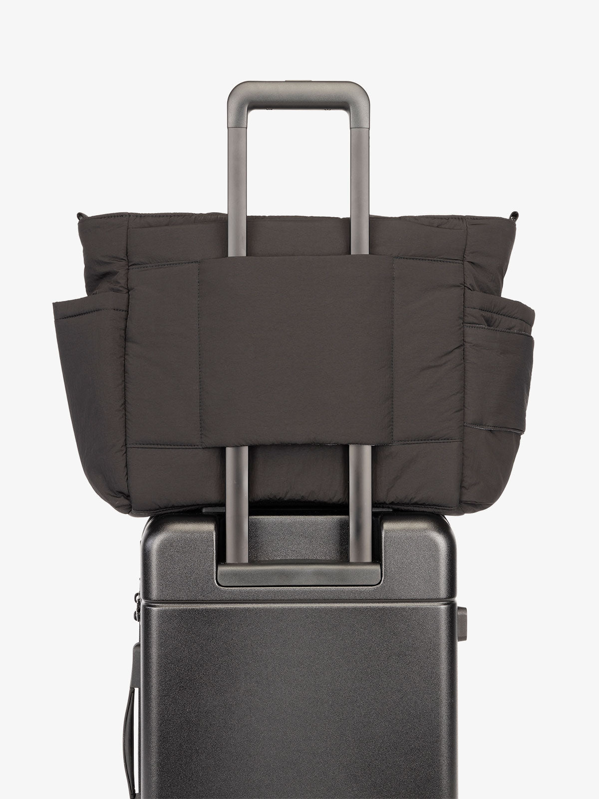 CALPAK Diaper Tote Bag with Laptop Sleeve featuring luggage trolley sleeve with back pocket in black; TBB2401-BLACK