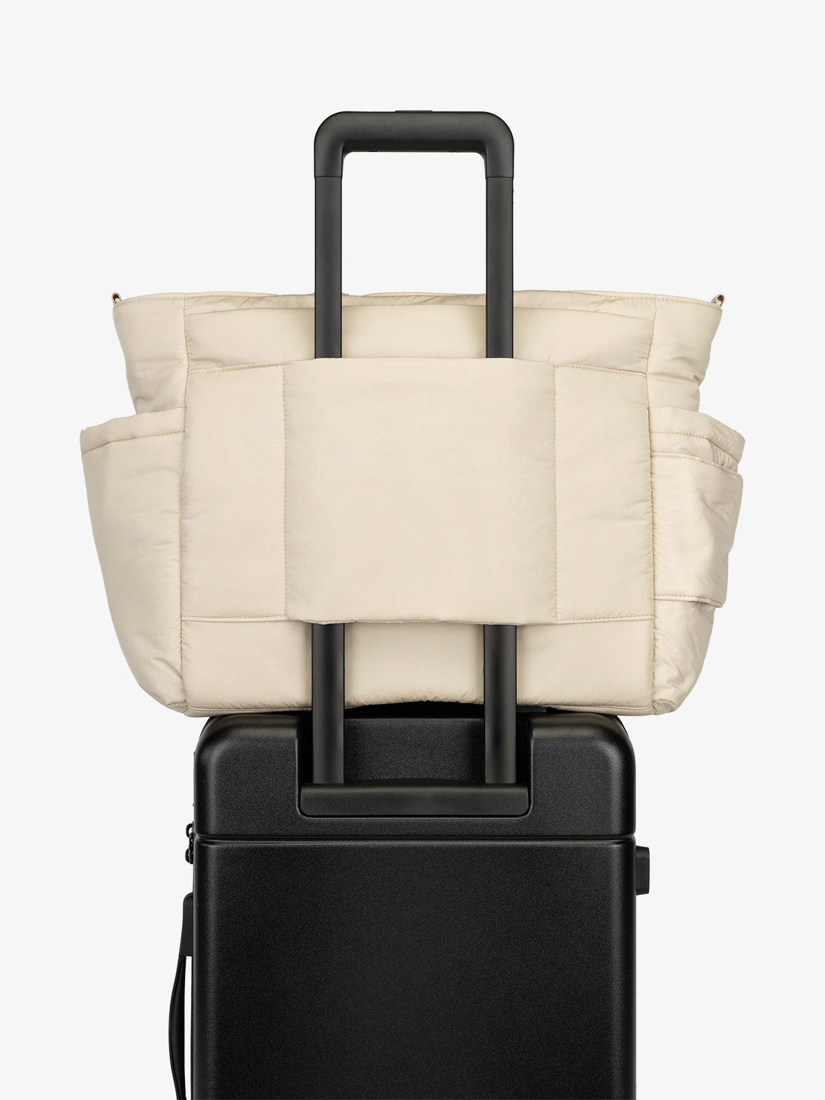 CALPAK Diaper Tote Bag with Laptop Sleeve featuring luggage trolley sleeve with back pocket in oatmeal beige; TBB2401-OATMEAL