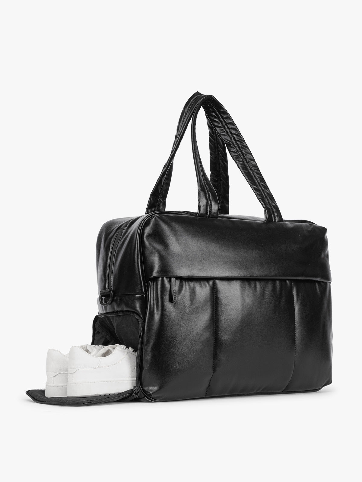 Side shoe compartment of Black CALPAK Luka Large Duffel in vegan leather with dual top handles, shown against a plain white background; DLL2201-BLACK-PU