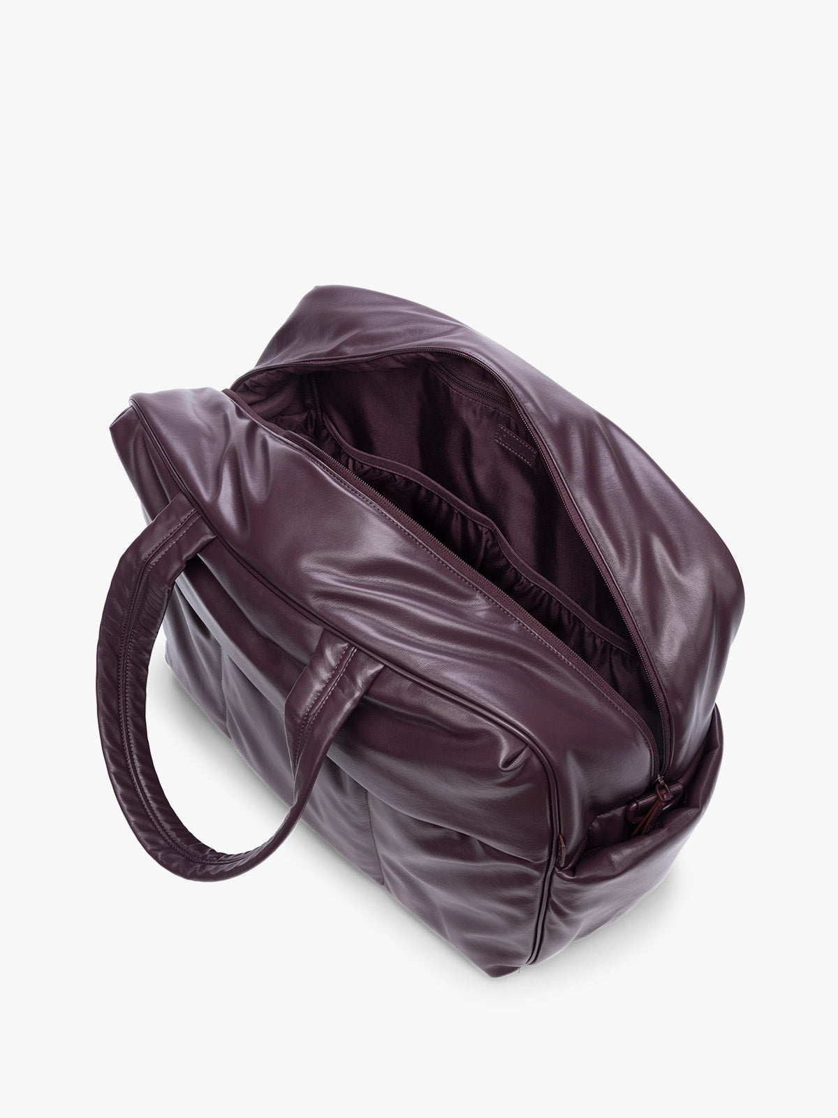 Top view with open zipper showing inside of Dark Cherry deep burgundy CALPAK Luka Large Duffel in vegan leather with dual top handles, shown against a plain white background; DLL2201-DARK-CHERRY-PU