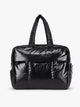 A shiny black puffer-style CALPAK Luka Large Duffel Bag with two top handles, photographed against a clean white studio background; DLL2201-GLAZED-BLACK