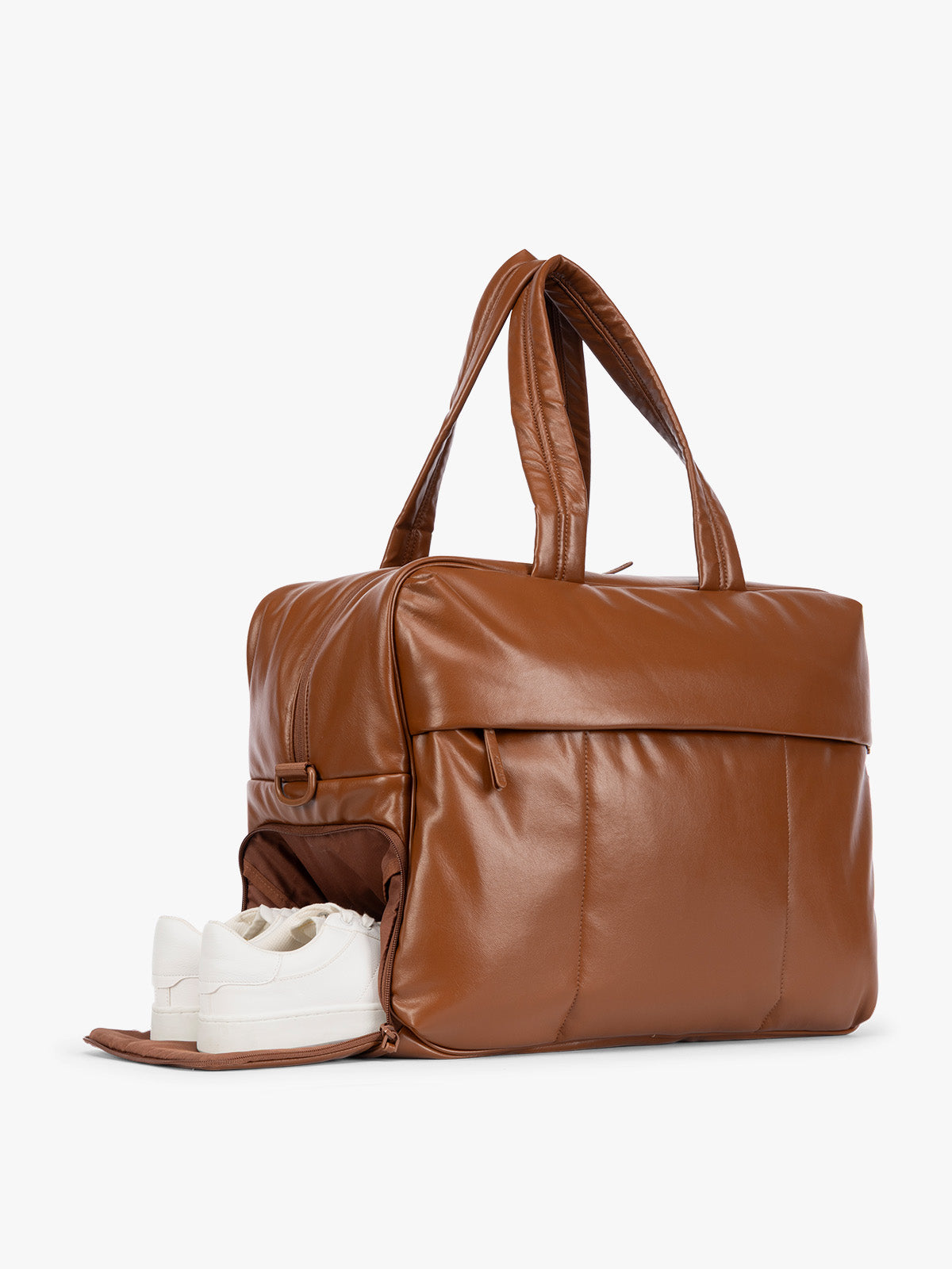 Side shoe compartment of Honey Brown CALPAK Luka Large Duffel in vegan leather with dual top handles, shown against a plain white background; DLL2201-HONEY-BROWN-PU