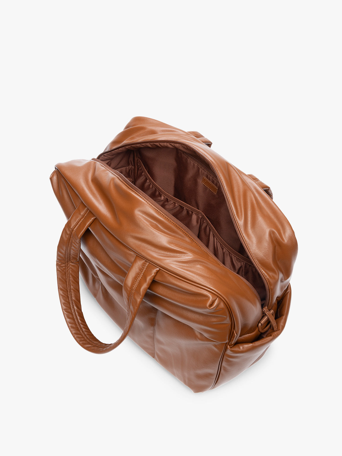 Side view showing inside of Honey Brown CALPAK Luka Large Duffel in vegan leather with dual top handles, shown against a plain white background; DLL2201-HONEY-BROWN-PU