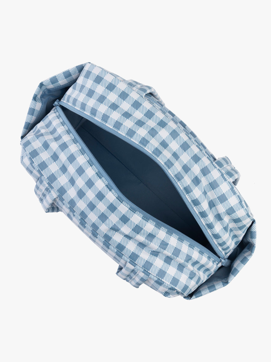 Opened view of CALPAK Luka Mini Duffel in white and blue gingham print in French Blue Gingham; DLM2501-FRENCH-BLUE-GINGHAM