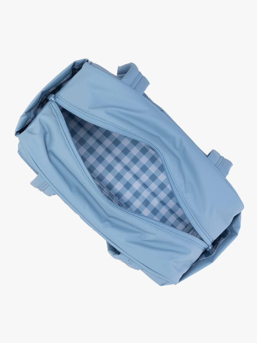 Opened view of CALPAK Luka Mini Duffel in light blue French Blue with white and blue gingham print interior; DLM2501-FRENCH-BLUE