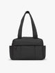 CALPAK Mini Duffel in black front view with puffy exterior, interior and exterior pockets, and padded shoulder straps; DLM2501-MATTE-BLACK