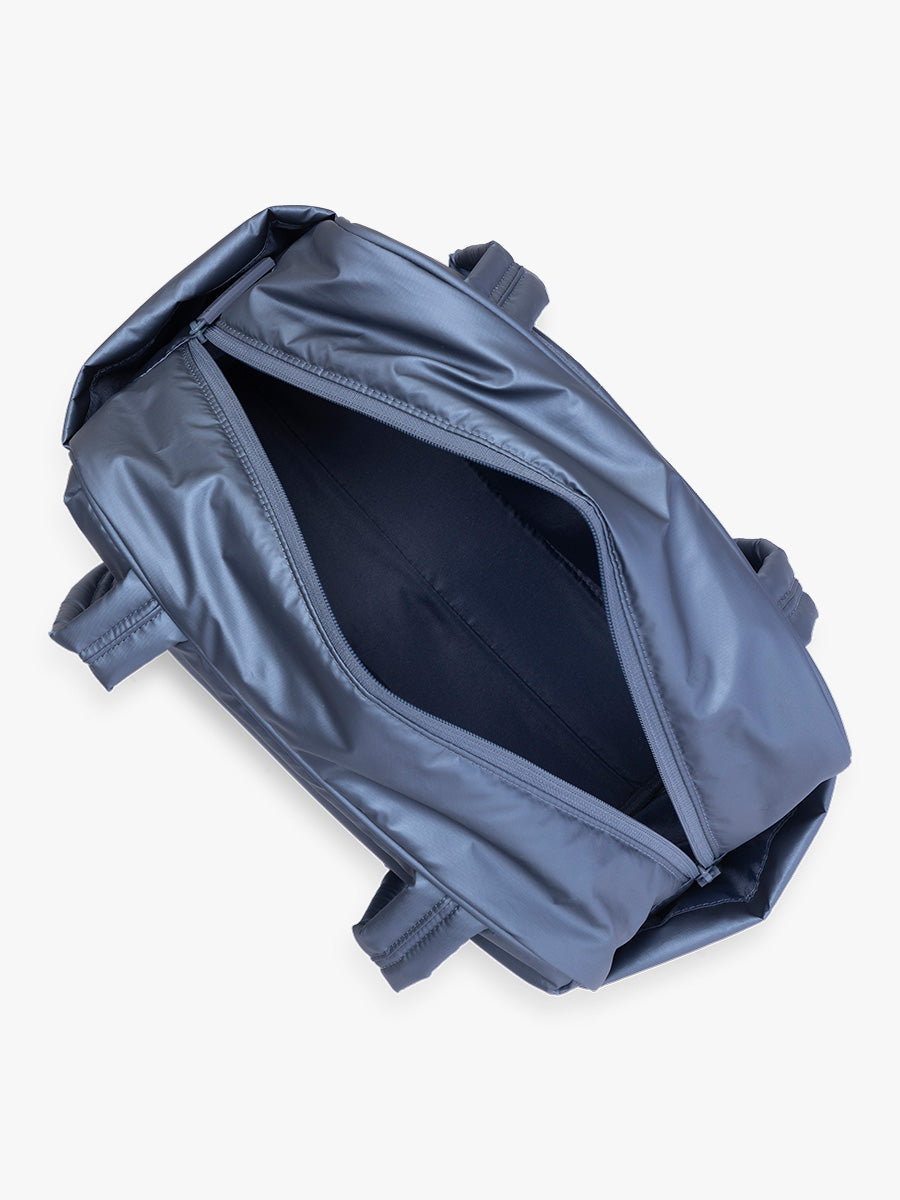 Opened view of CALPAK Luka Mini Duffel in metallic dark blue Metallic Indigo; DLM2501-METALLIC-INDIGO
