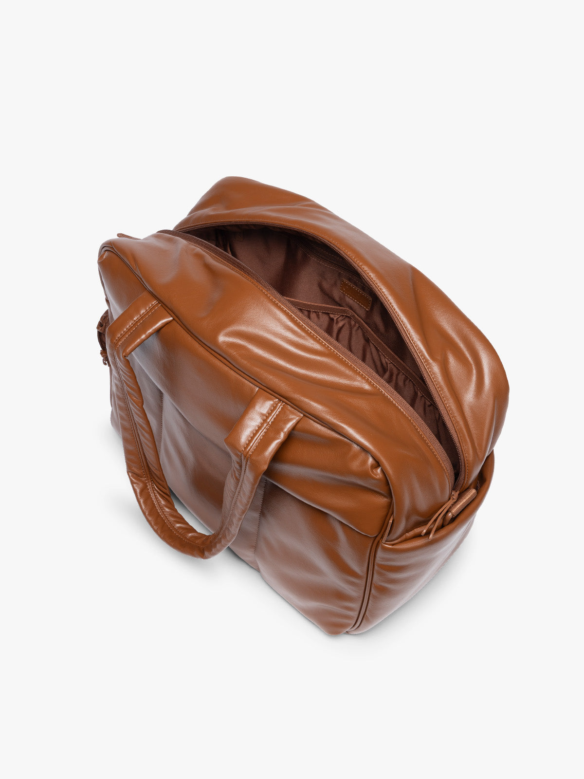 Top view with zipper open showing the inside of Honey Brown CALPAK Luka Duffel in vegan leather with dual top handles and a front zippered pocket, photographed against a clean white background; DSM1901-HONEY-BROWN-PU
