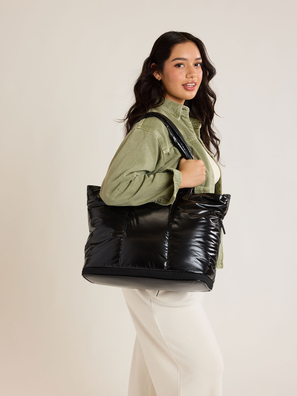 Model with CALPAK Luka Expandable Tote in Glazed Black; ALT2201-GLAZED-BLACK