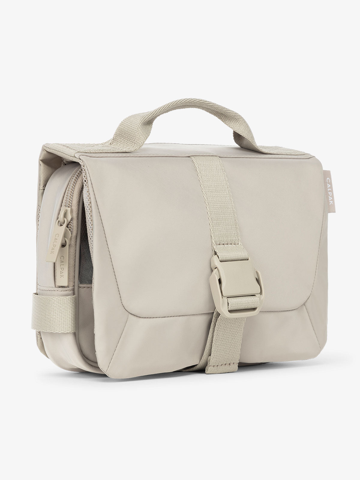 Side view of CALPAK Fit gym toiletry bag with durable carrying handle and made with 2 recycled water bottles in grayish beige; TFH2401-GREIGE, TFH2401-GREIGE-GRIN, BTBF2401-GREIGE