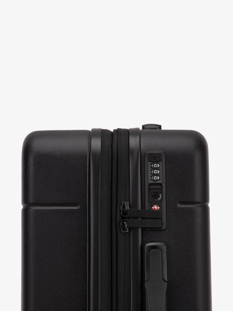TSA-approved lock on the CALPAK Hue Starter Bundle in Black that comes with Large and Carry On Luggage with op handle on a white background; LHU8000-BLACK