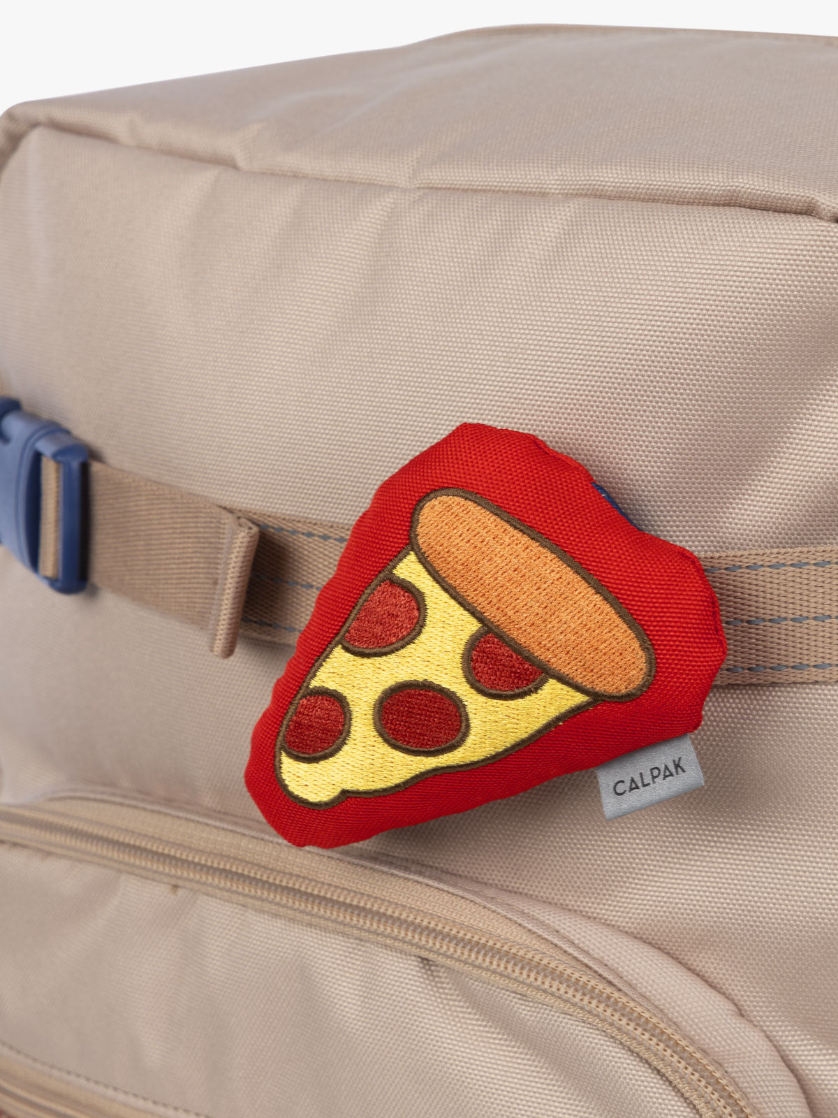 CALPAK Kids Collection red and yellow pepperoni Pizza Pluffy Bag Charm attached to Kids Large brown and tan Khaki Backpack; BCKL5000-KHAKI