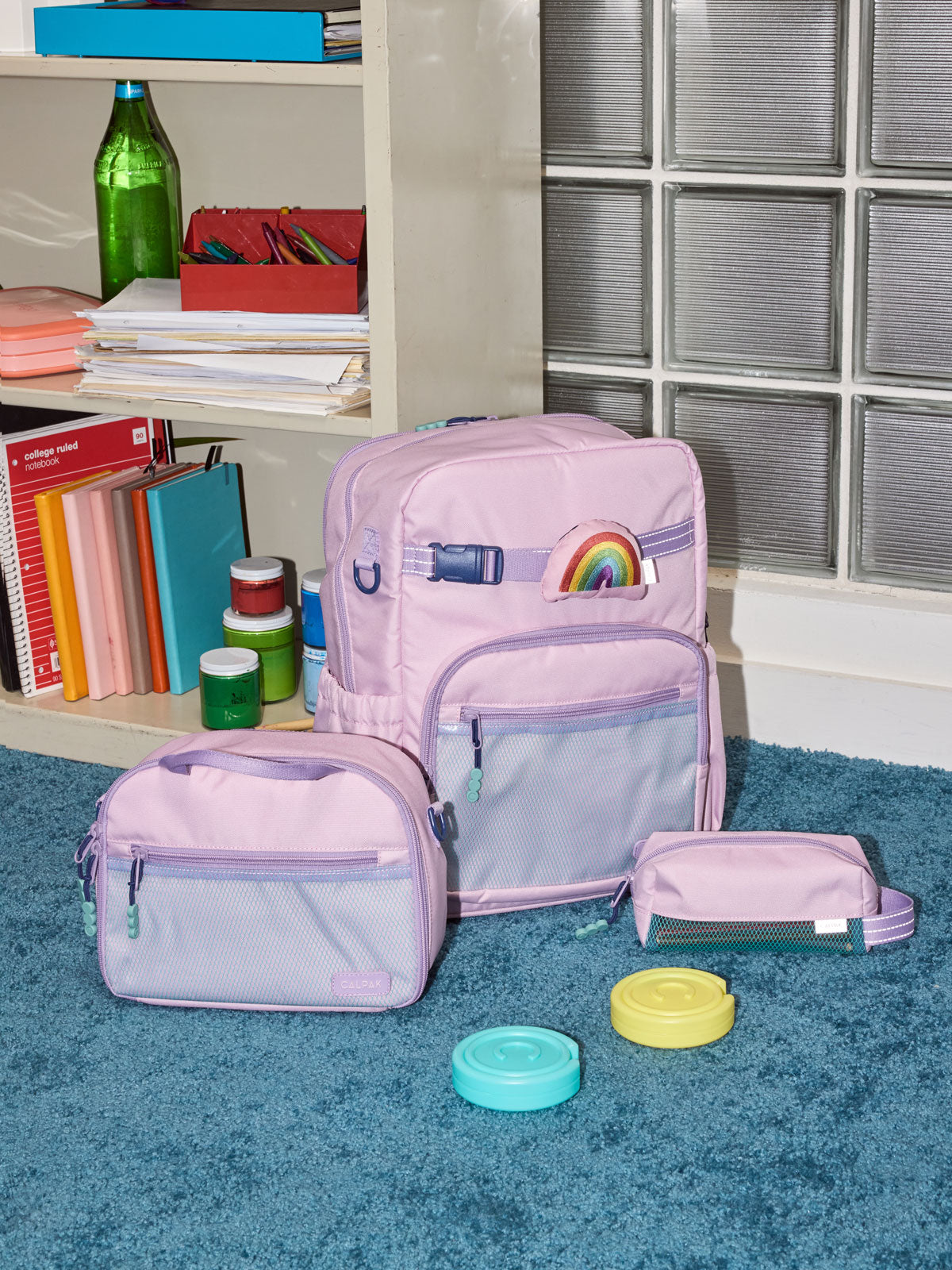 CALPAK Kids Large Backpack in lavender pink Orchid Pink for ages 8-12 side view with water bottle holder pocket; CKBL2501-ORCHID-PINK