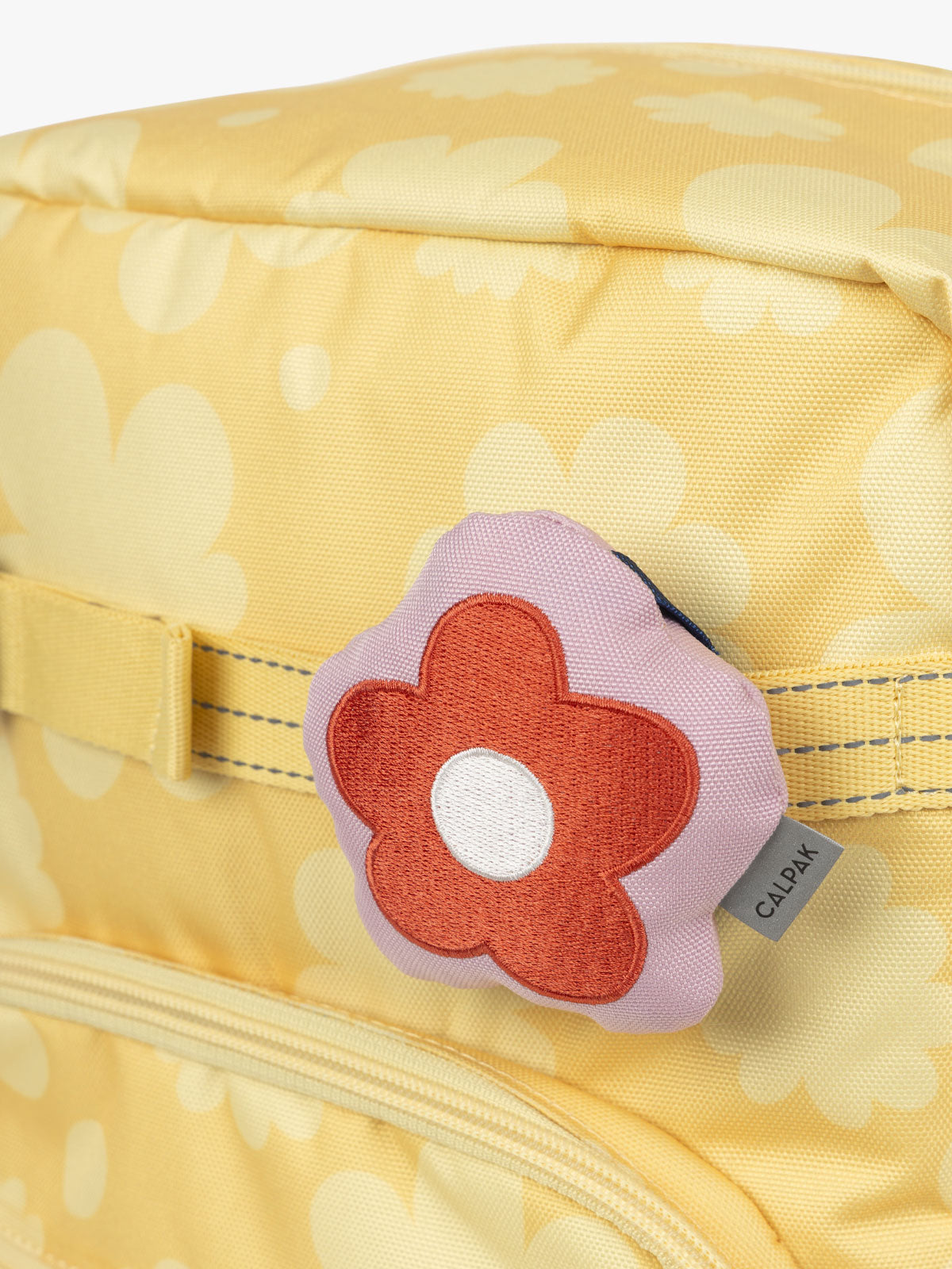 CALPAK Kids Collection red and pink Flower Pluffy Bag Charm attached to Kids Large yellow flower print Yellow Bloom Backpack; BCKL5000-YELLOW-BLOOM