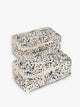 Closed view with zippers of the white and black animal print Snow Leopard rectangular CALPAK shoe cube with zippers and top handle shown on a plain background; KSB2001-SNOW-LEOPARD