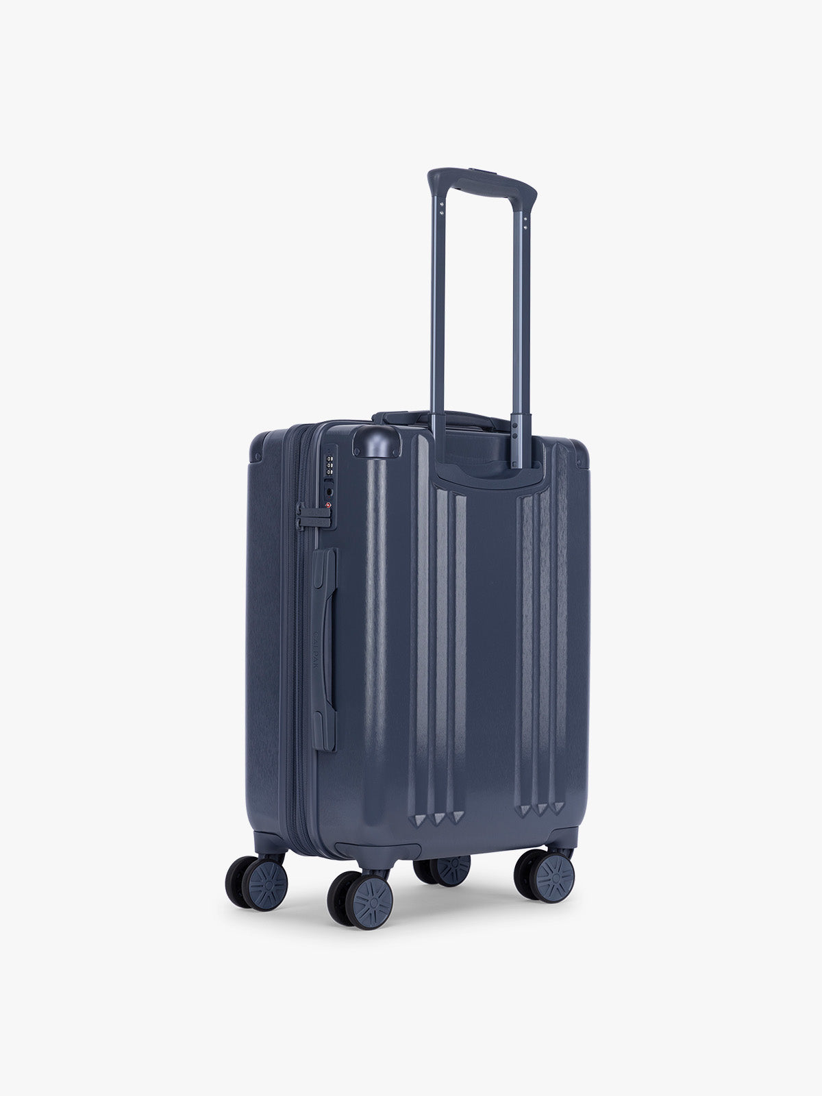 Back view of Model holding CALPAK Ambeur Carry On Luggage in dark blue metallic Indigo; LAM1020-INDIGO