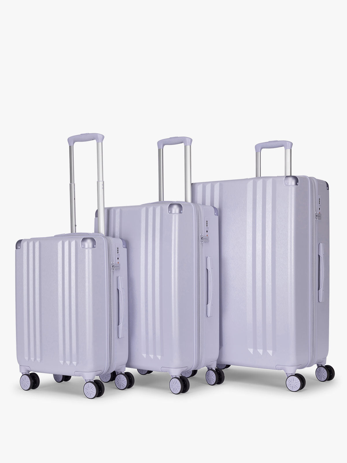 CALPAK Ambeur three piece luggage set in carry on, medium, and large sizes in light purple lavender with handles and spinner wheels on a white background; LAM3000-SEA-GLASS