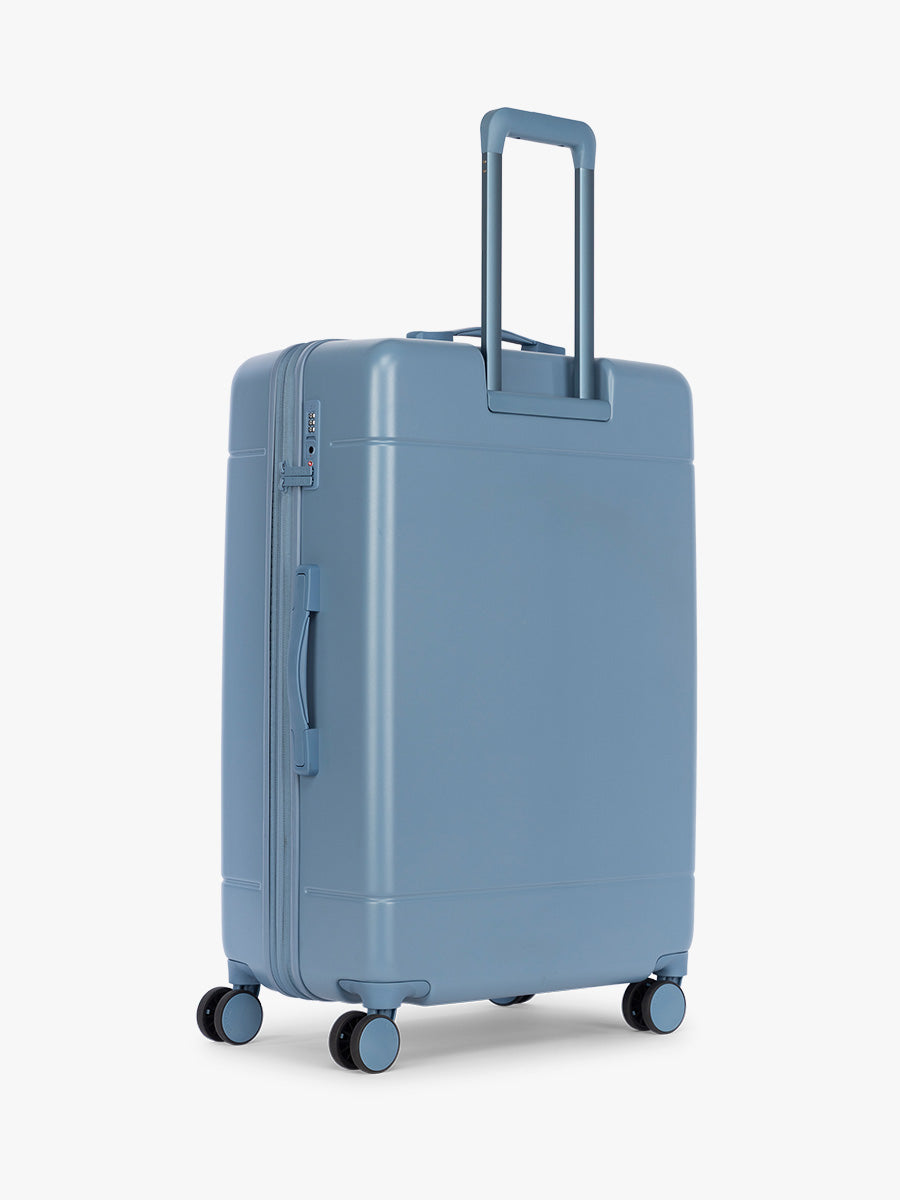 Back side of CALPAK Hue Large Luggage in light blue French Blue and blue and white gingham interior ; LHU1028-FRENCH-BLUE