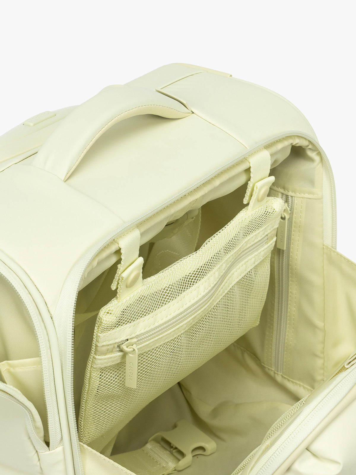 Interior mesh pocket of CALPAK Luka Soft-Sided Mini Carry On Luggage in light green Celadon with spinner wheels and handle; LSM1014-CELADON
