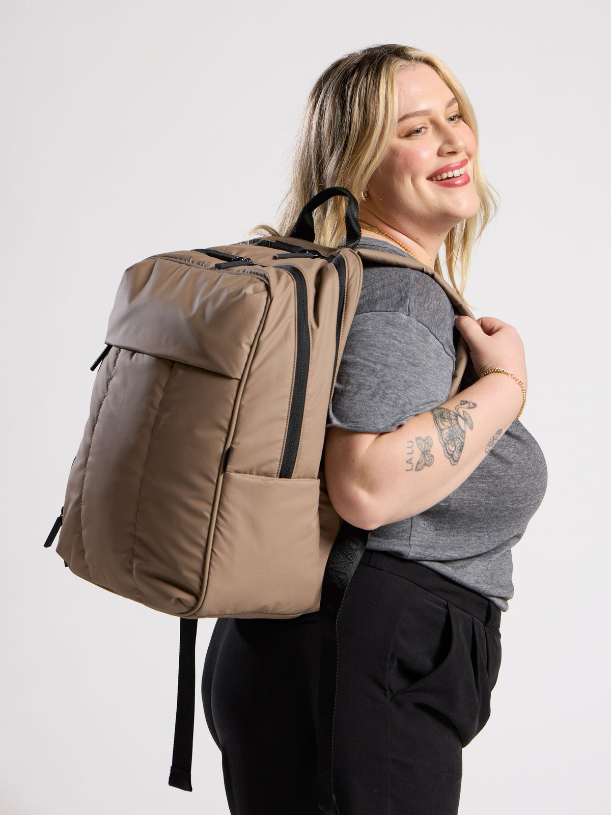 Model wearing luka laptop backpack for 17 inch laptop on back in brown; BPX2301-CHOCOLATE
