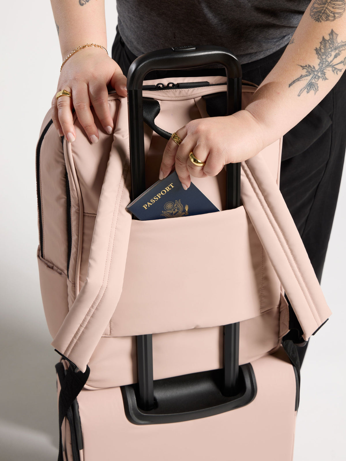 CALPAK Luka 17 inch Laptop Backpack featuring adjustable straps and luggage trolley pass through with hidden pocket for belongings in pink; BPX2301-ROSE-QUARTZ