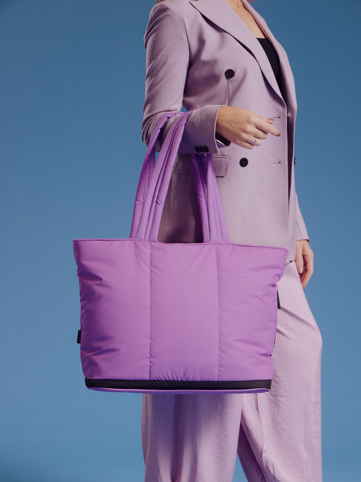 Model wearing CALPAK Luka Expandable Laptop Tote in lilac over forearm; ALT2201-LILAC