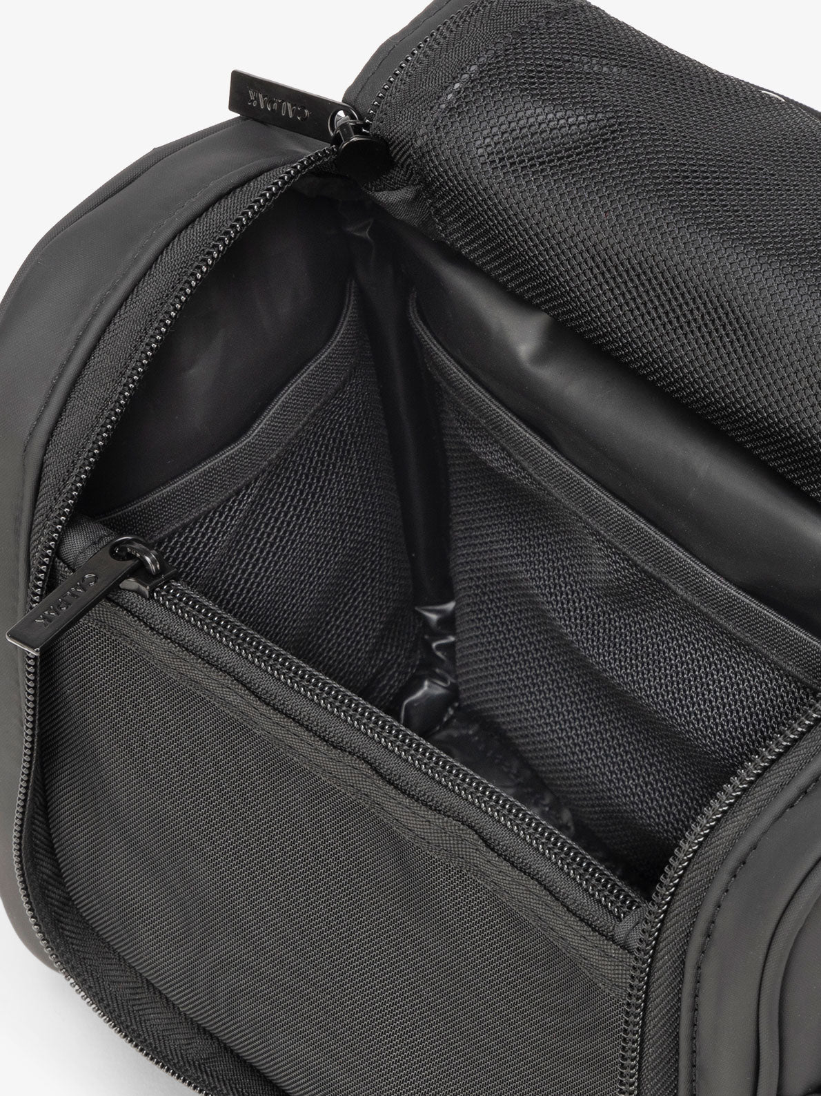 CALPAK Luka Hanging Toiletry Bag with water-resistant lining and mesh pockets for toiletries and makeup in matte black; TLH2301-MATTE-BLACK