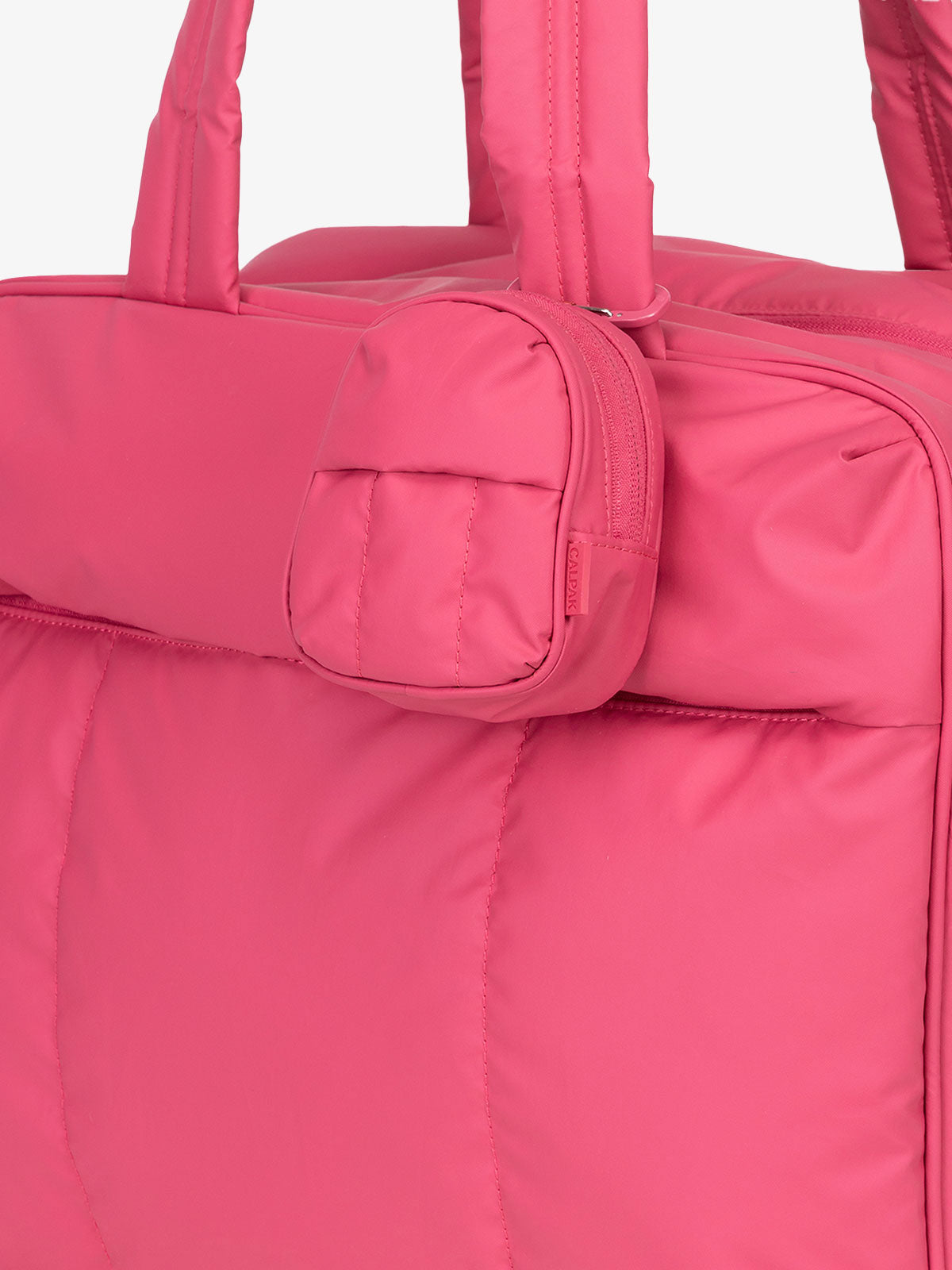 CALPAK Luka mini backpack keychain attached to duffel with carabiner clip in pink; AMB2201-DRAGONFRUIT