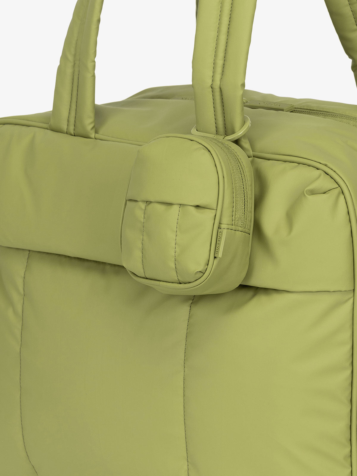 CALPAK Luka mini backpack keychain attached to duffel with carabiner clip in green; AMB2201-PISTACHIO