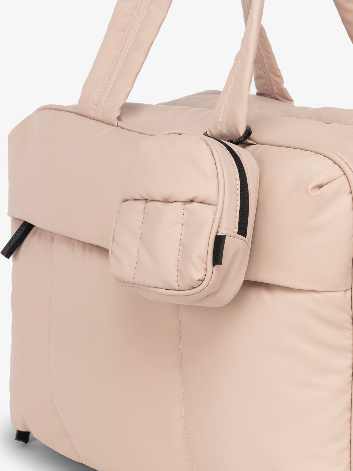 CALPAK Luka mini backpack keychain attached to duffel with soft, water-resistant exterior in rose quartz; AMB2201-ROSE-QUARTZ