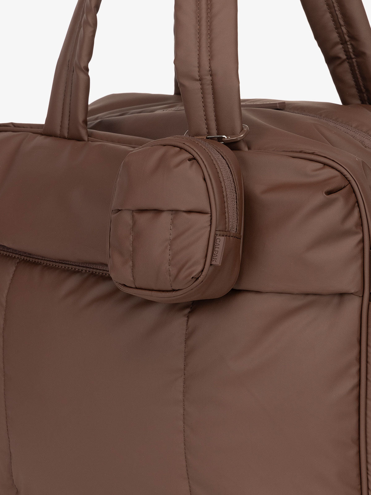 CALPAK Luka mini backpack keychain attached to duffel with carabiner clip in dark brown; AMB2201-WALNUT