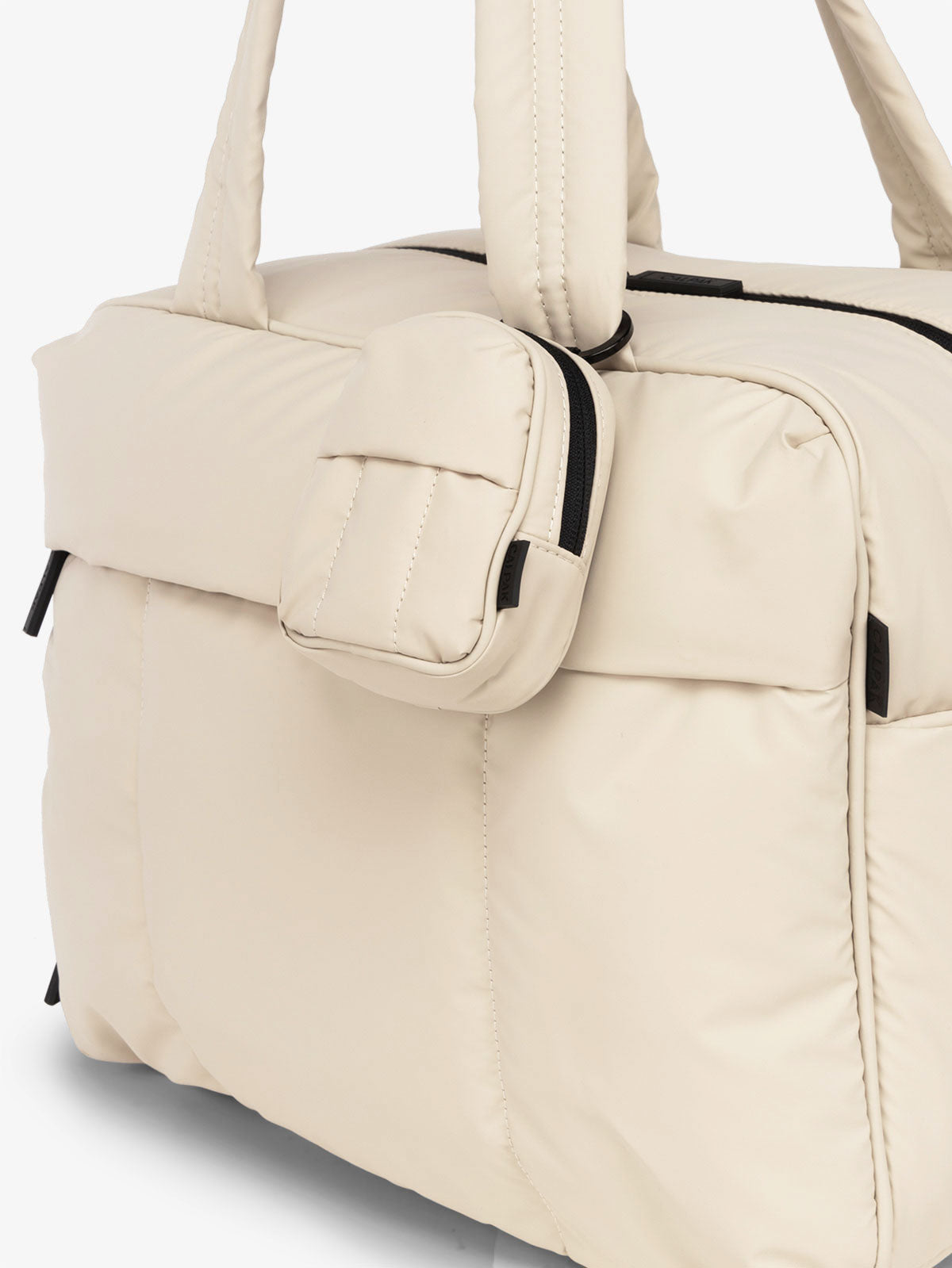 CALPAK Luka mini backpack keychain attached to duffel with soft, water-resistant exterior in oatmeal; AMB2201-OATMEAL