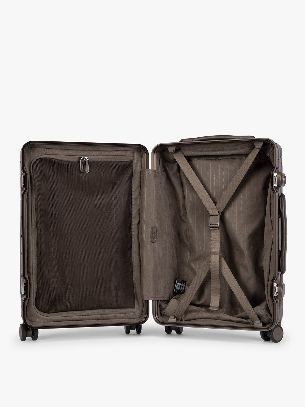 Opened CALPAK Vault brown Mushroom hard-shell spinner Carry On Luggage with a telescoping handle extended, featuring a black leatherette side handle and trim, set against a plain light gray background; LVT1020-MUSHROOM
