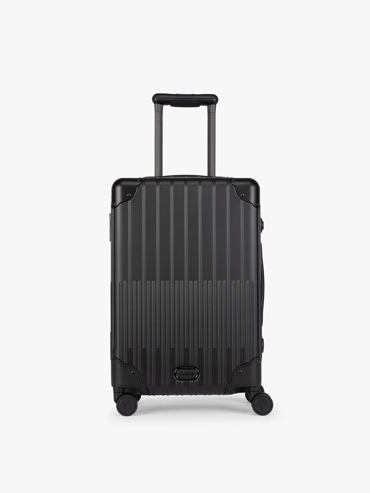 CALPAK Vault black Onyx hard-shell spinner Carry On Luggage with a telescoping handle extended, featuring a Black leatherette side handle and trim, set against a plain light gray background; LVT1020-ONYX