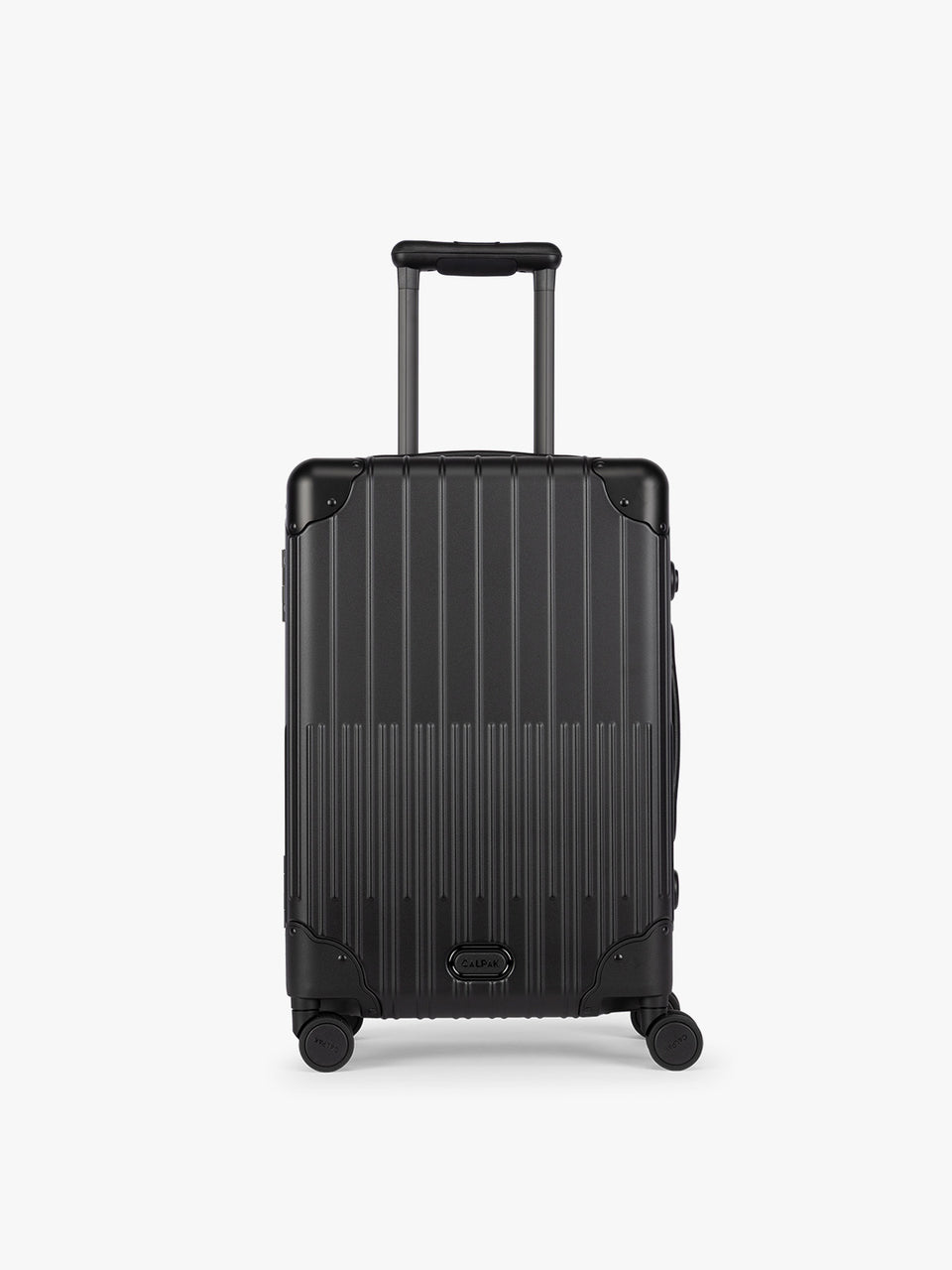 CALPAK Vault black Onyx hard-shell spinner Carry On Luggage with a telescoping handle extended, featuring a Black leatherette side handle and trim, set against a plain light gray background; LVT1020-ONYX