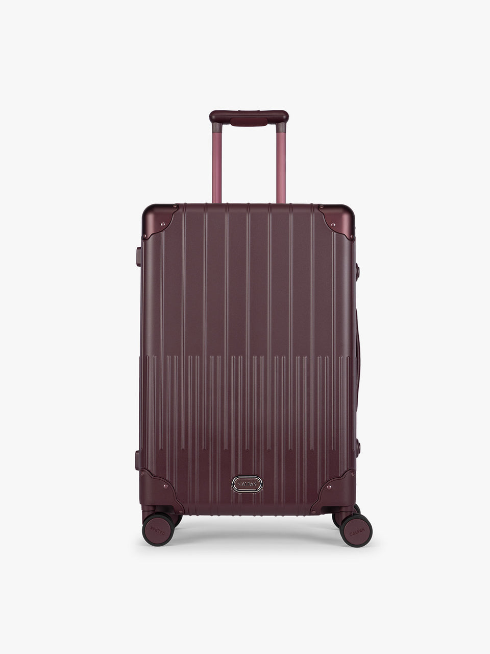 CALPAK Vault Luggage in Medium Dark Cherry deep red hard-shell spinner suitcase with a ribbed vertical design, shown from the front against a clean white background; LVT1024-DARK-CHERRY