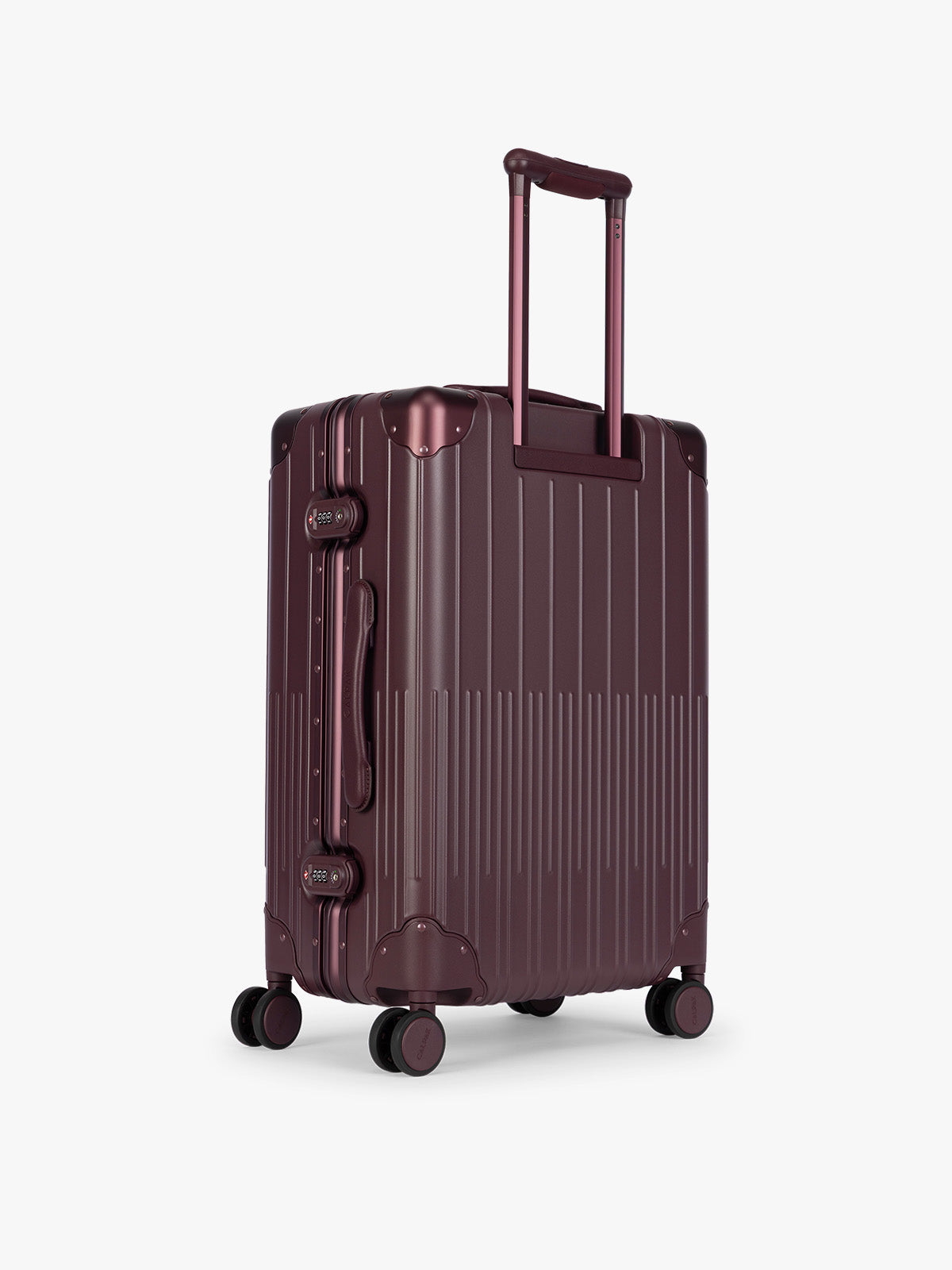Backside of CALPAK Vault Luggage Dark Cherry deep red hard-shell spinner suitcase with a ribbed vertical design, shown from the front against a clean white background; LVT1024-DARK-CHERRY