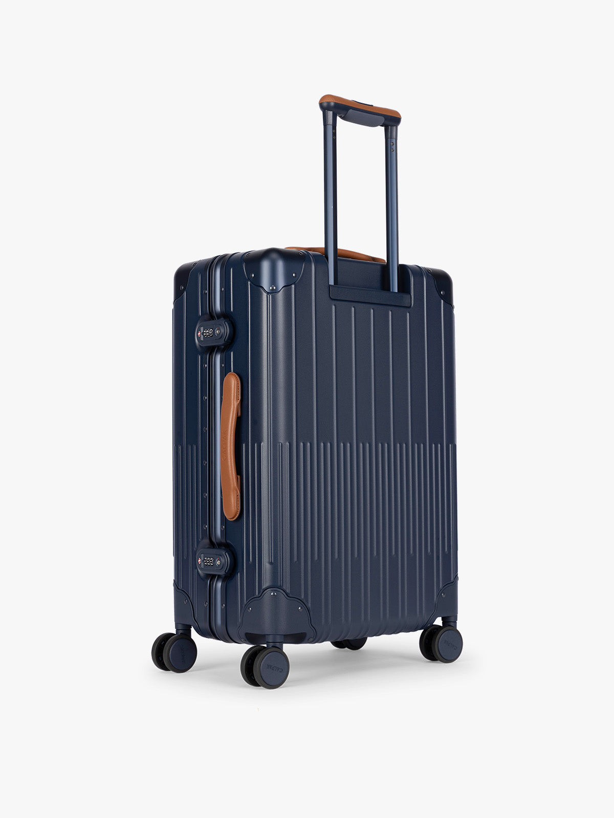 Backside of CALPAK Vault Luggage blue Navy hard-shell spinner suitcase with a ribbed vertical design, shown from the front against a clean white background; LVT1024-NAVY