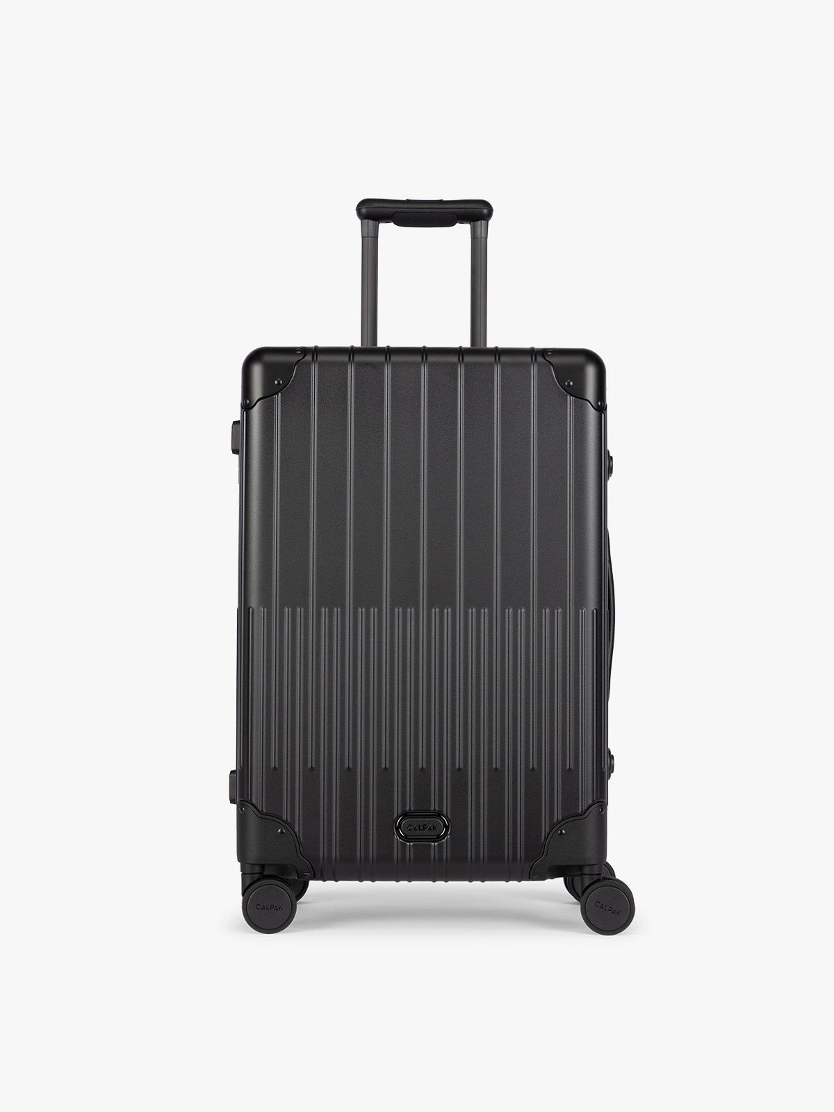 CALPAK Vault Luggage Onyx black hard-shell spinner suitcase with a ribbed vertical design, shown from the front against a clean white background; LVT1024-ONYX