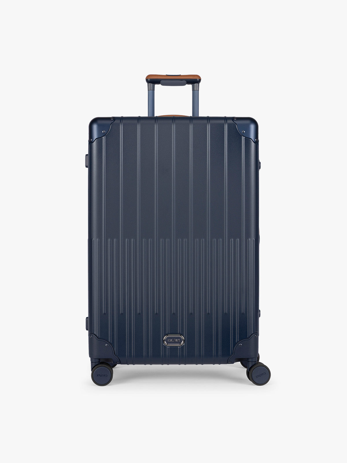 CALPAK Large Vault Luggage in blue Navy with hard-shell spinner suitcase with a ribbed vertical design, shown from the front on a light gray background; LVT1028-NAVY